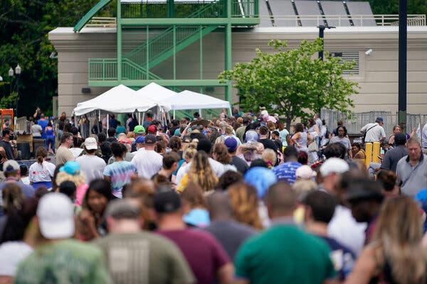 A crowd thronged a temporary unemployment office in Kentucky in June. Adapting computer systems to new benefits has been a crucial factor in processing claims.