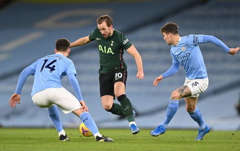 Tottenham Hotspur captain Harry Kane dribbles past Manchester City defenders at a past match