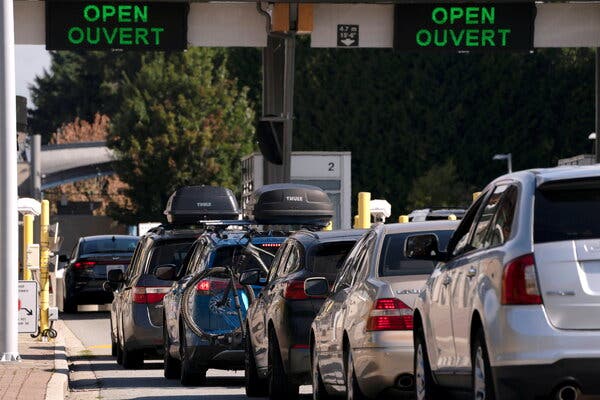People crossed the U.S.-Canadian border after Canada opened the border to vaccinated Americans in Blaine, Wash., in August. The United States will open the border for vaccinated visitors from Canada and Mexico.