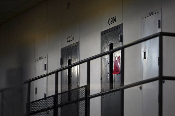 A red tag on a cell door indicating an active Covid-19 case at Faribault Prison in Minnesota in January. Many U.S. jails and prisons have struggled with coronavirus outbreaks.