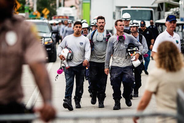 Search and rescue crews exiting the site of the Champlain Towers South collapse in Surfside, Fla., on Monday.