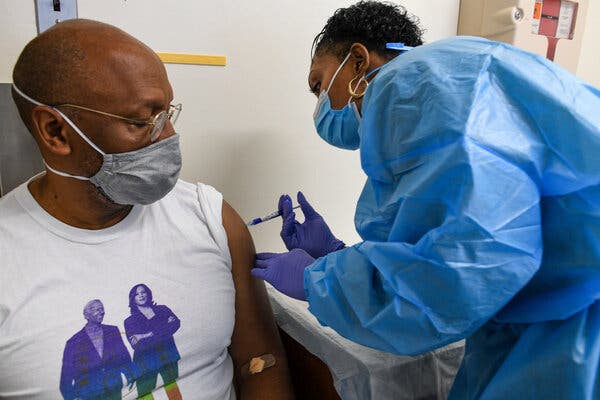 Registered Nurse Dionne Dias injecting John Gray with the Novavax Vaccine which is undergoing Phase III safety/efficacy trials at Howard University Hospital in Washington in January.