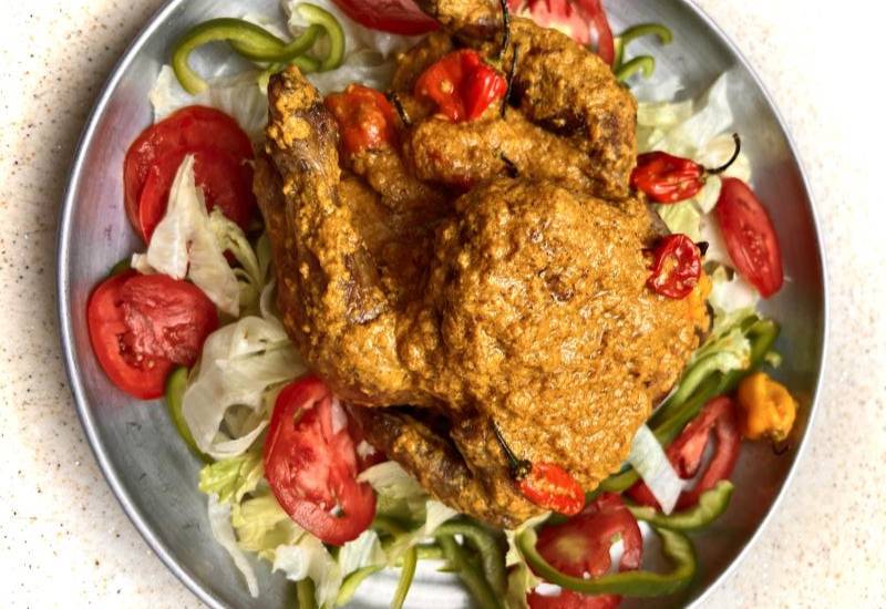 Whole chicken in coconut sauce Eve woman