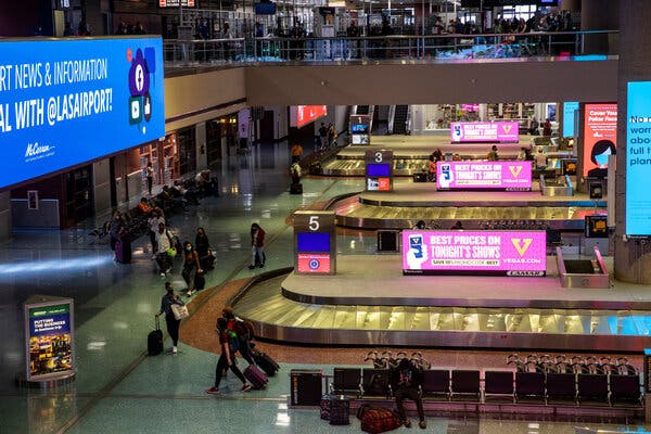 Americans whose passports expired overseas during the pandemic can use them to get home, the State Department said. Passengers walked through the baggage claim area at the Las Vegas airport. 