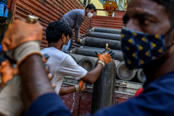 Oxygen cylinders outside a shop in South Delhi. A court said it would start punishing government officials for failing to deliver oxygen.
