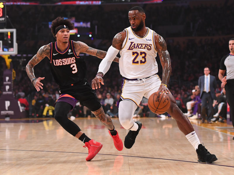Jan 1, 2020; Los Angeles, California, USA; Phoenix Suns forward Kelly Oubre Jr. (3) guards Los Angeles Lakers forward LeBron James (23) as he drives to the basket in the first half of the game at Staples Center. \[Jayne Kamin-Oncea-USA TODAY Sports\]