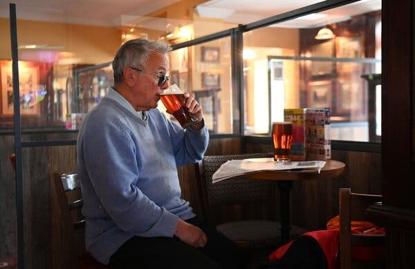 An early pint indoors at a pub in London on Monday.