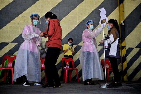 Taking temperatures at a vaccination site in Bangkok on Tuesday.