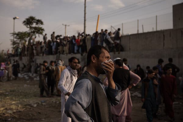 A crowd waiting by an entrance to the international airport in Kabul, Afghanistan, on Sunday.