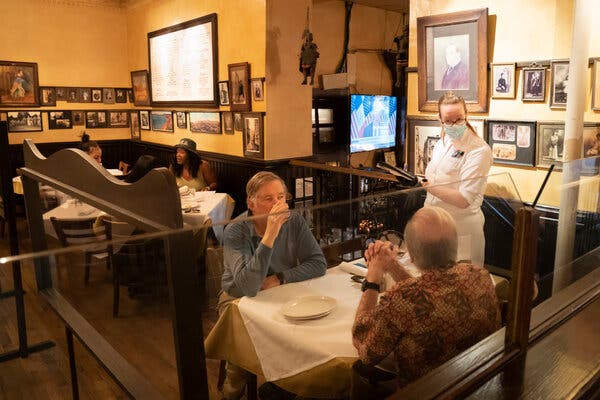 At Carmine's restaurant on the Upper West Side on Tuesday, plastic dividers were in between tables. 