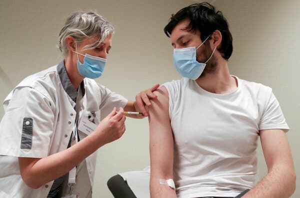 A volunteer in Brussels participating in a study of the CureVac vaccine, a new RNA vaccine that could help meet that global need.