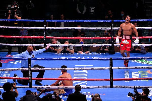 Elvis Rodriguez, right, after his knockout win against Juan Pablo Romero in their super lightweight bout.