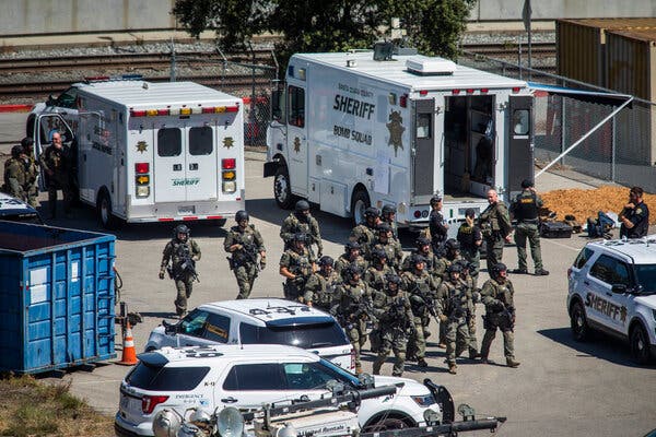 Law enforcement officers in the light rail yard in San Jose where a gunman killed eight people.