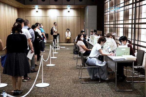 Waiting in line to receive a Covid-19 vaccine in Tokyo in July.