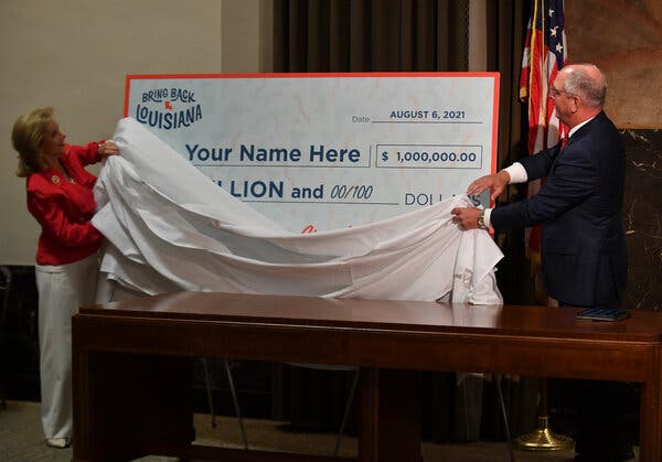 Gov. John Bel Edwards of Louisiana and his wife, Donna Edwards, at a news conference last week announcing cash prizes and scholarships to encourage vaccination.