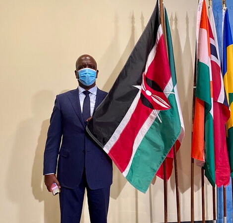 The Permanent Representative of Kenya to the United Nations, Martin Kimani, posing with Kenyan flag