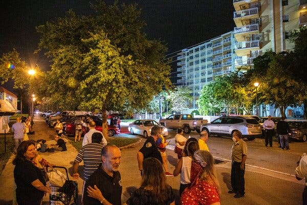 Residents of Crestview Towers condominium stood outside the building on Friday as it was being evacuated. The city of North Miami Beach deemed the building unsafe after receiving an engineer’s report outlining structural and electrical problems.