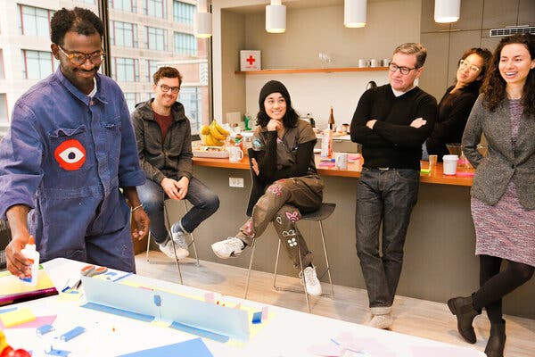 Maceo Paisely, left, an experience designer, presents a prototype for a grief ritual at an event hosted by Sacred Design Lab.
