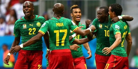 Cameroon National Football Team players celebrate a goal at an AFCON match