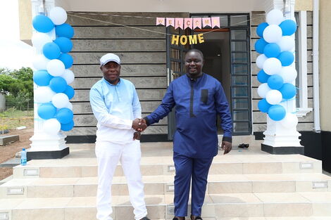 Gordon Paul Ogada (in blue) at the official opening of his new home in Migori County 