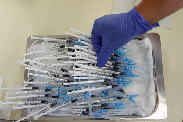 Medical staff prepare a dose of the Pfizer BioNTech vaccine in Sant Vicenc de Casteller, north of Barcelona, this month.