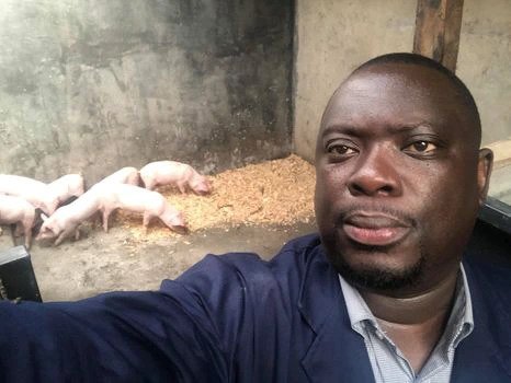 Mike Njenga takes a selfie with piglets at his farm. He is involved in several ventures. 
