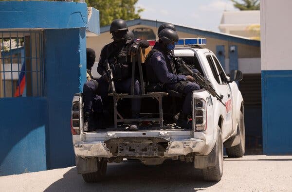 Haitian police officers on Saturday entering an area in the capital, Port-au-Prince, where suspects in the assassination are being held.