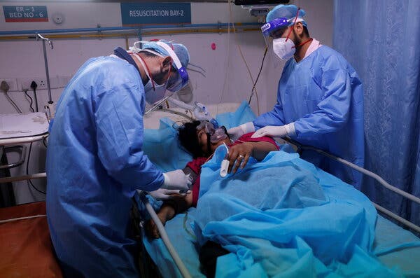 Medical workers tending to a coronavirus patient in an emergency room in New Delhi last week.