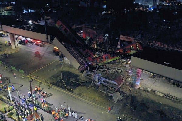 Rescue workers at the site where a train plunged off an overpass that partly collapsed on Monday night in Mexico City.