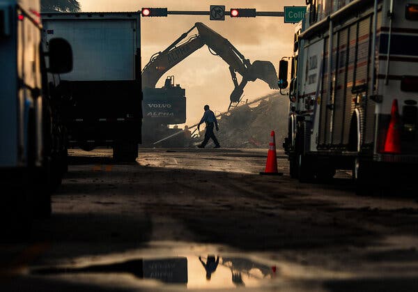 Rescuer workers used heavy equipment to remove debris as search efforts entered a third day on Saturday at the site where the Champlain Towers South collapsed in Surfside, Fla.