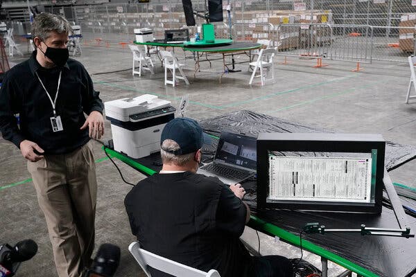 Doug Logan, left, the chief executive of the Florida-based company Cyber Ninjas, in Phoenix in April.