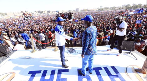 ODM party leader Raila Odinga and Wiper's Kalonzo Musyoka shake hands after Kalonzo endorsed him for the presidency at Jacaranda Grounds on Saturday, March 12, 2022