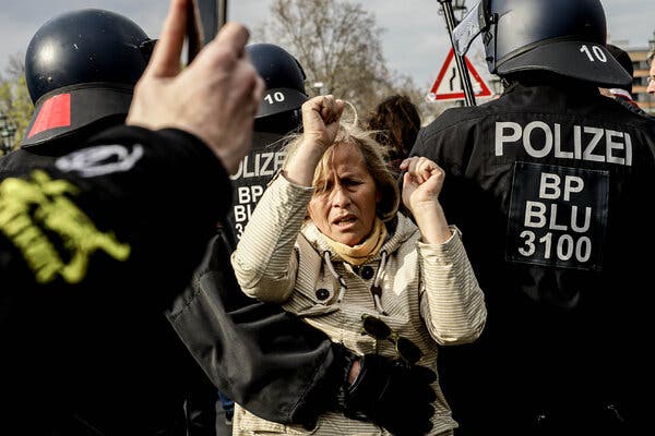 Police officers carrying off a demonstrator who was protesting coronavirus restrictions at a rally in Berlin on April 21.