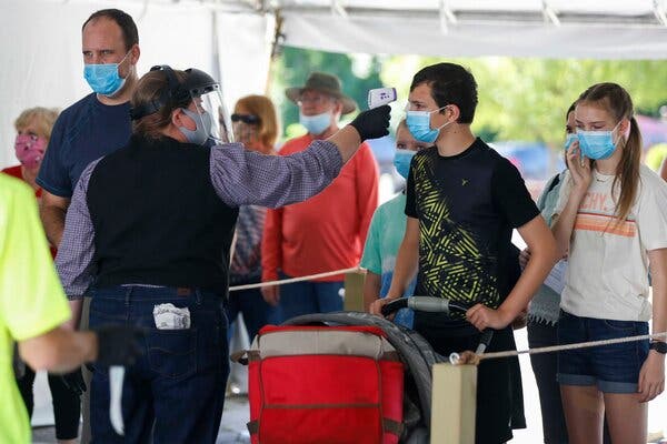 Guests at the Silver Dollar City amusement park in Branson, Mo., had their temperatures checked last month. The spike in daily reported virus cases has been especially pronounced in Branson.