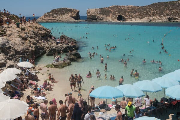 A beach in Comino, Malta, on Sunday. The country’s government said that most of the people who tested positive for the coronavirus recently were foreign nationals who had not been inoculated.