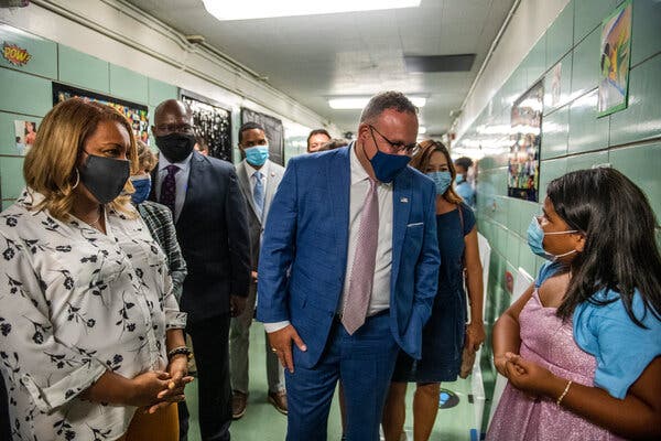 The secretary of education, Miguel Cardona, speaking with Mia Arias, 10, during a visit to a New York elementary school on Tuesday.