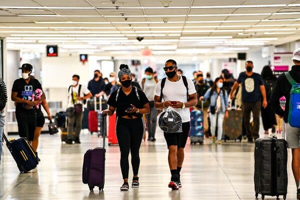 Travelers arrive at Miami International Airport ahead of the Memorial Day weekend, last week.