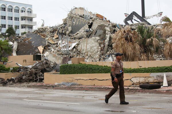 A view from Collins Avenue of the crumpled remains of Champlain Towers South in Surfside, Fla.