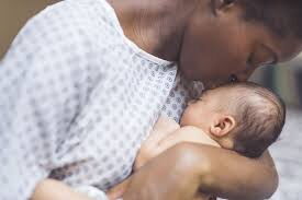 Picture of a mother caressing her newborn