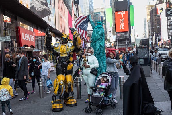 Visitors from Baltimore posing with characters in Times Square in May.