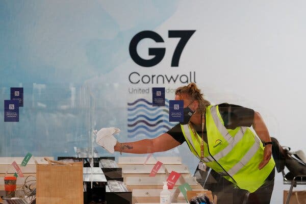 A worker cleaning partitions at the Group of 7 media center in Falmouth, Cornwall, on Thursday.