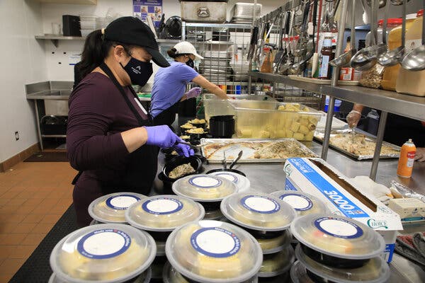 Volunteers and staff members preparing meals at a food bank operated by Samaritan House in San Mateo, Calif., on Wednesday.