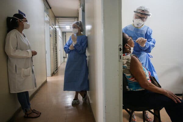 A health worker collecting a swab sample from a woman to test for the coronavirus after cases of the Omicron variant were detected in Porto Alegre, Brazil, last week.