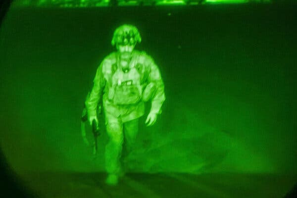 A photograph released by U.S. Central Command shows Maj. Gen. Chris Donahue, commander of the U.S. Army 82nd Airborne Division, boarding a C-17 cargo plane at Kabul’s airport on Monday. He was the final American service member to depart Afghanistan.