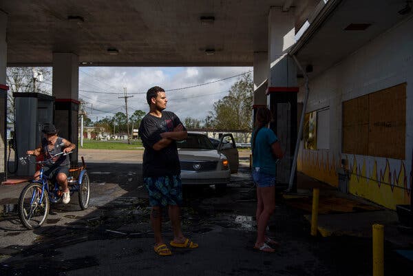 Residents line up outside a gas station in southeast Louisiana on Monday, waiting to make purchases. Hurricane Ida will almost certainly exacerbate shipping and material shortages.