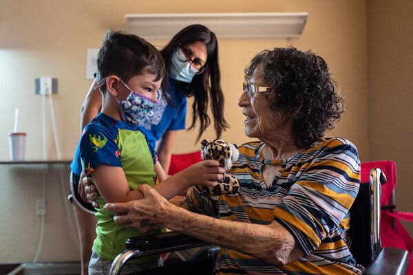 Aurora Duran, 86, with her great-grandson, Kason Driver, at a long-term-care facility in Fort Stockton, Texas, this month. Around the country, nursing homes are beginning to allow family members to visit for the first time since the pandemic began.
