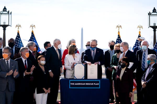 Senate Majority Leader Chuck Schumer and House Speaker Nancy Pelosi displayed the American Rescue Plan Act during an enrollment ceremony at the Capitol in March.