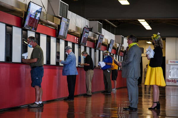 Spectators placing their bets at Pimlico Race Course on Saturday.
