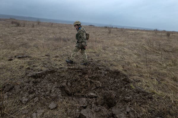 A Ukrainian soldier on Friday in the Luhansk region of eastern Ukraine, near a crater left by shelling. A conflict with separatists has been under way there for years.  