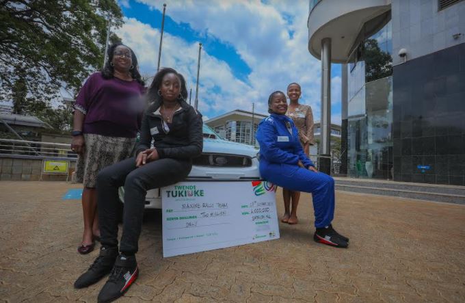 Rally Driver Maxine Wahome (R) and her co-driver Linet Ayuko (L) pose for a picture after Safaricom’s sponsorship cheque handover.